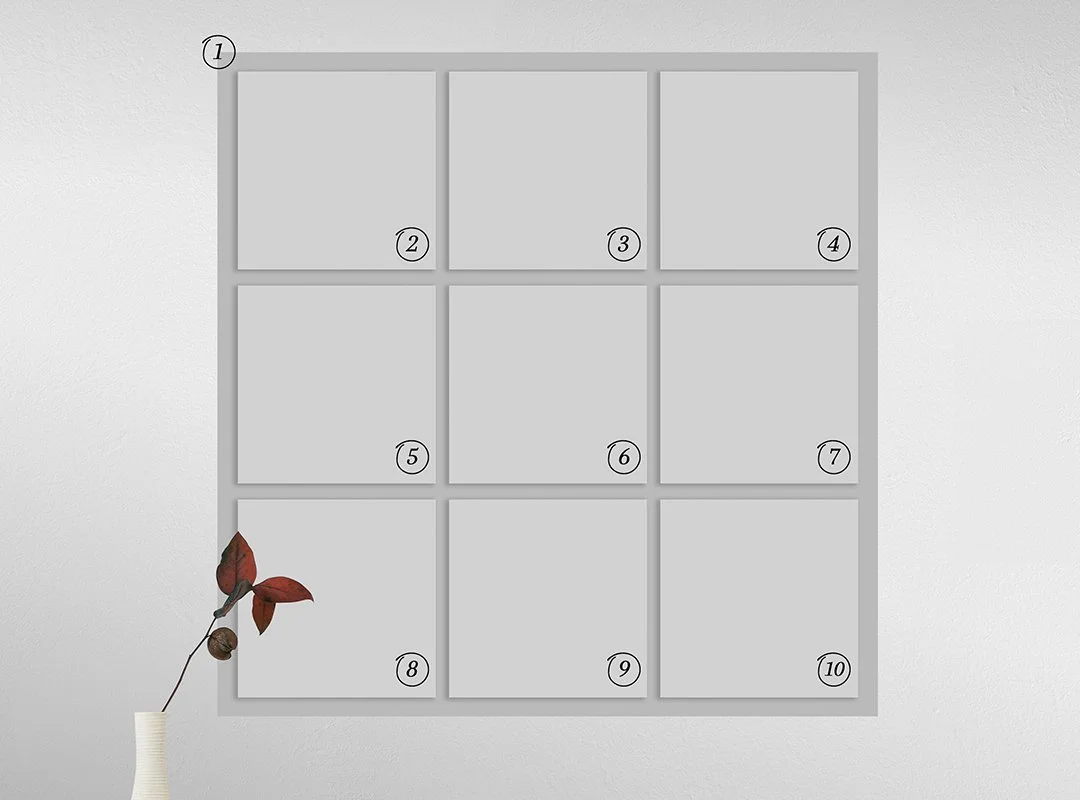 Empty gray grid with 10 numbered sections on a white wall, with a small white vase containing a branch with red leaves and pine cone at the bottom left.