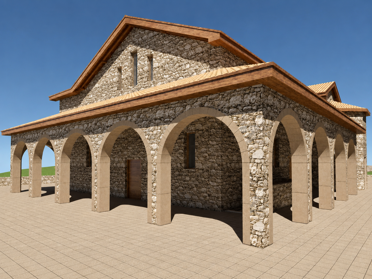A stone building with arched doorways and windows under a gabled roof with wood accents, set on a tiled courtyard against a clear blue sky.