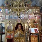 An ornate religious altar with icons, gold decorations, and religious artifacts.