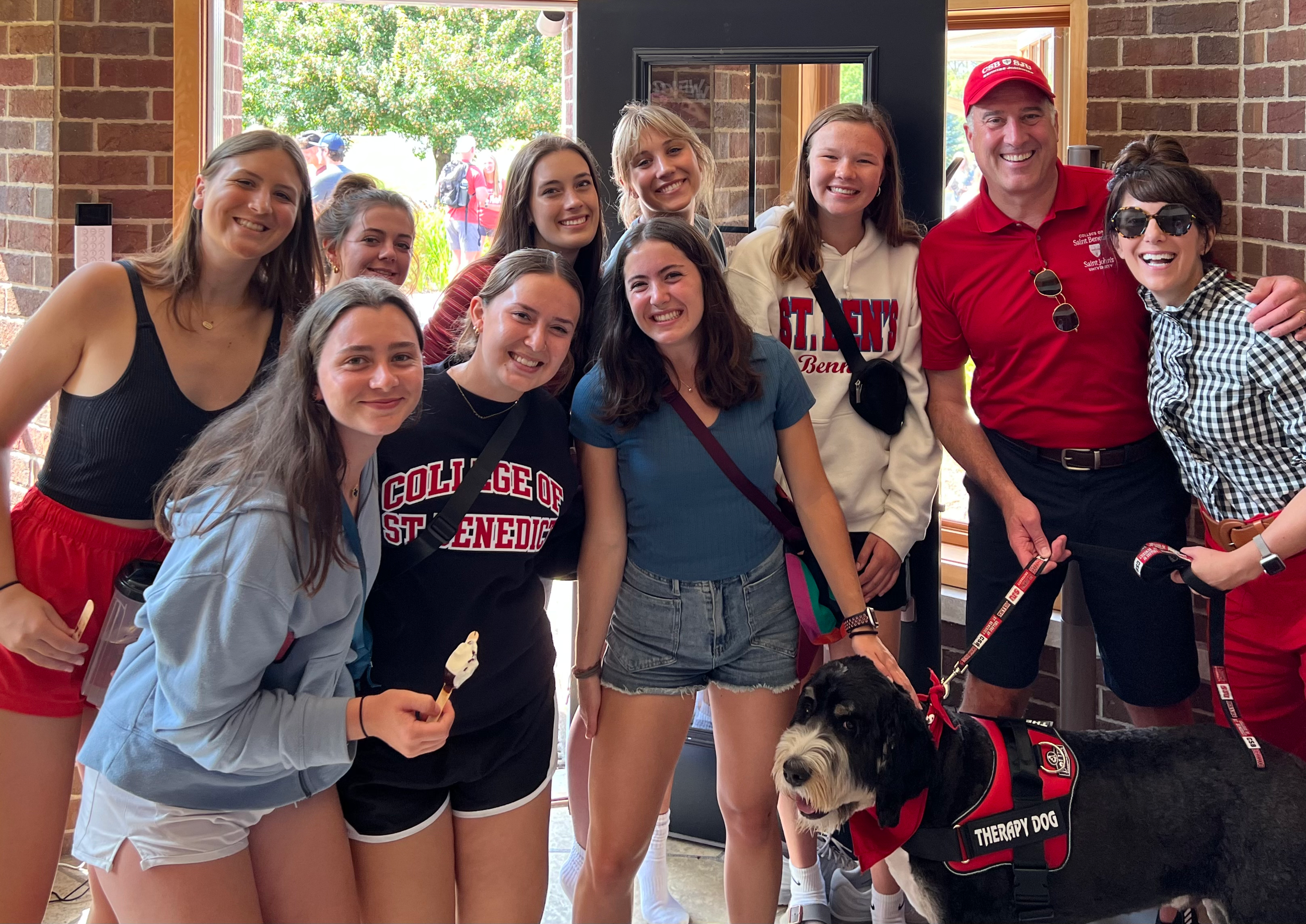 Carol and Brian Bruess with a group of CSB students
