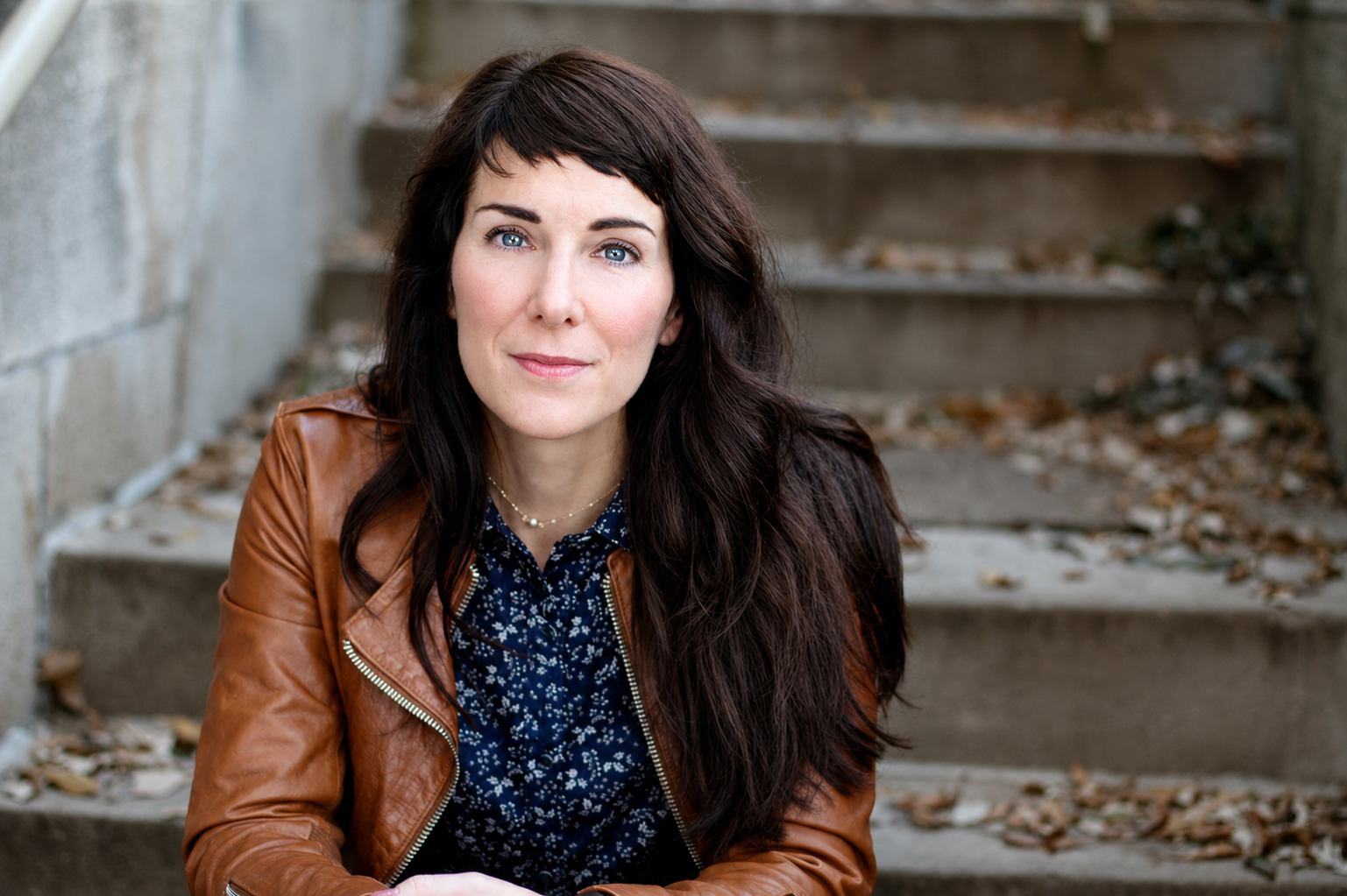 Carol Bruessheadshot serious on steps leather jacket