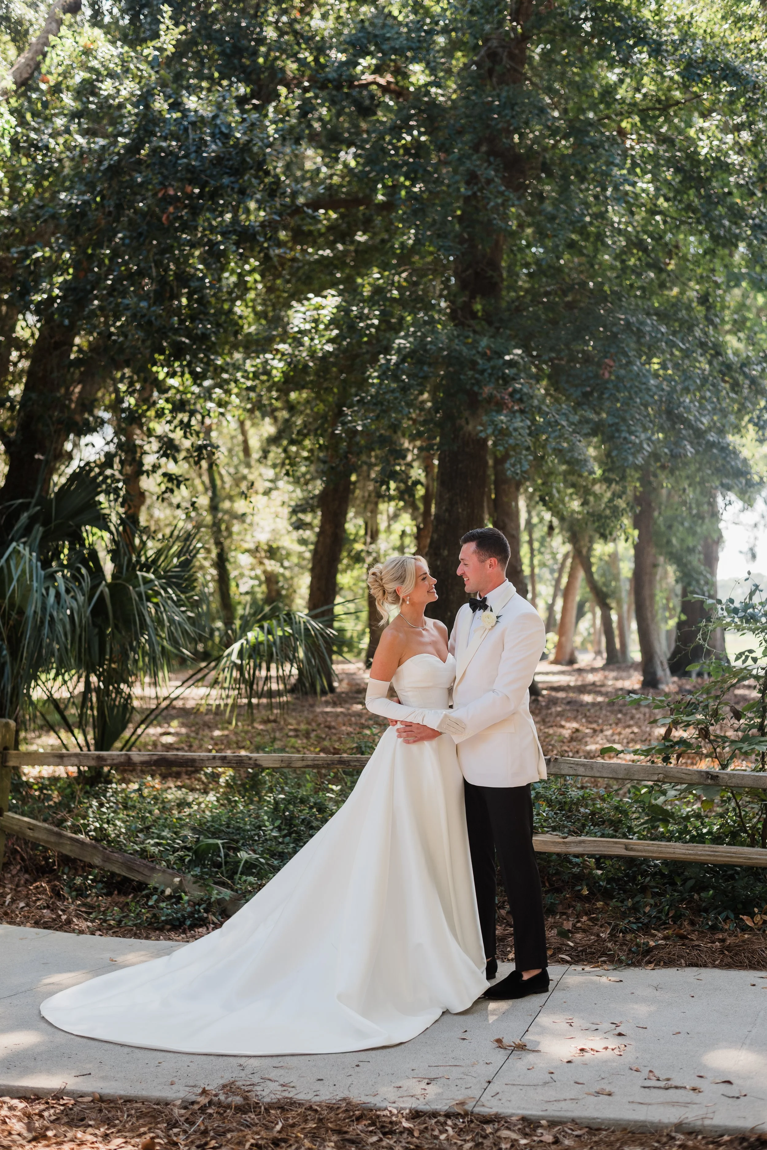 Laurie’s customers, Fernando and Kate embracing by the lake on their wedding day.