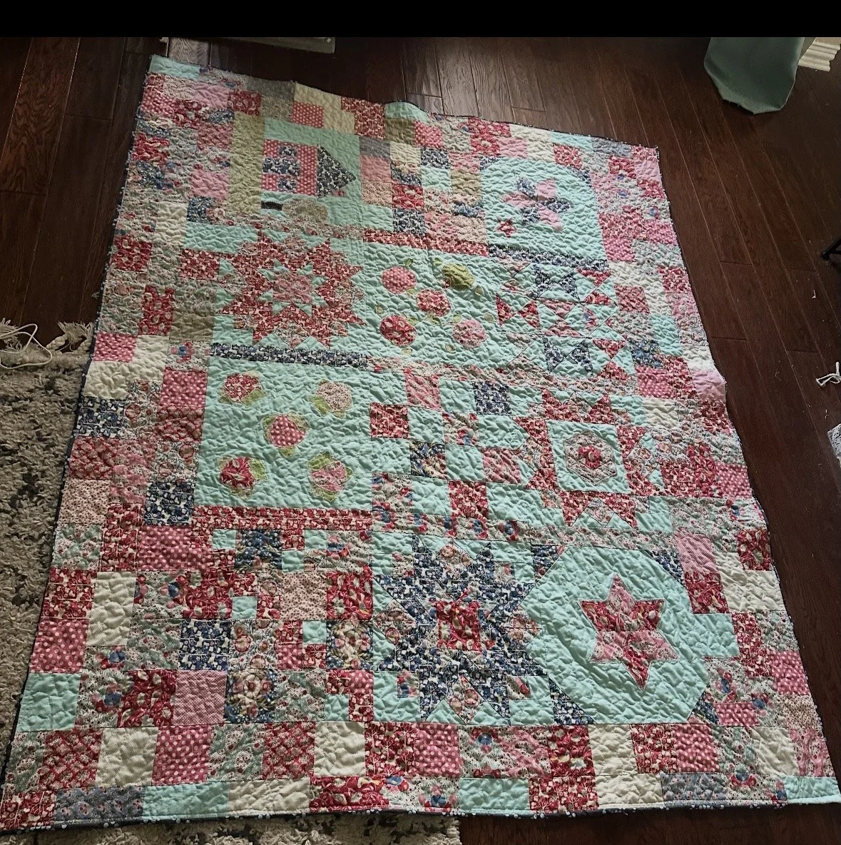 This is my favorite quilt and the one on my bed that I use daily. I made a couple of stars from a pattern, made several blocks with EPP and appliquéd them on (along with some berries) and pieced the rest. It was made with Tilda's Jubilee fabric. (dro