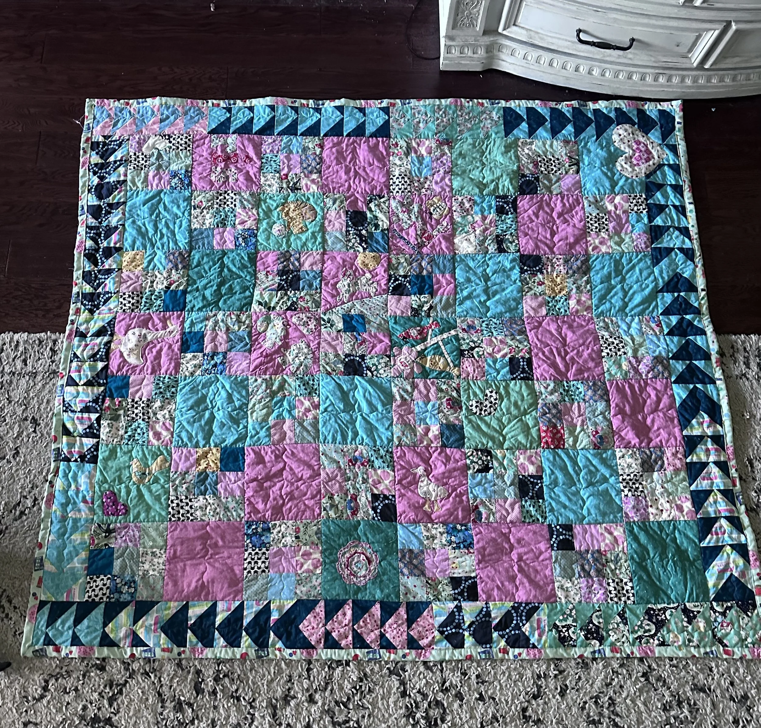 This is my personal winter quilt. It cheers me up to see these colors when it is cold. I recently ripped off the binding and added these flying geese to the borders instead of the plain one I had and I'm thrilled with the results. Eventually, every b