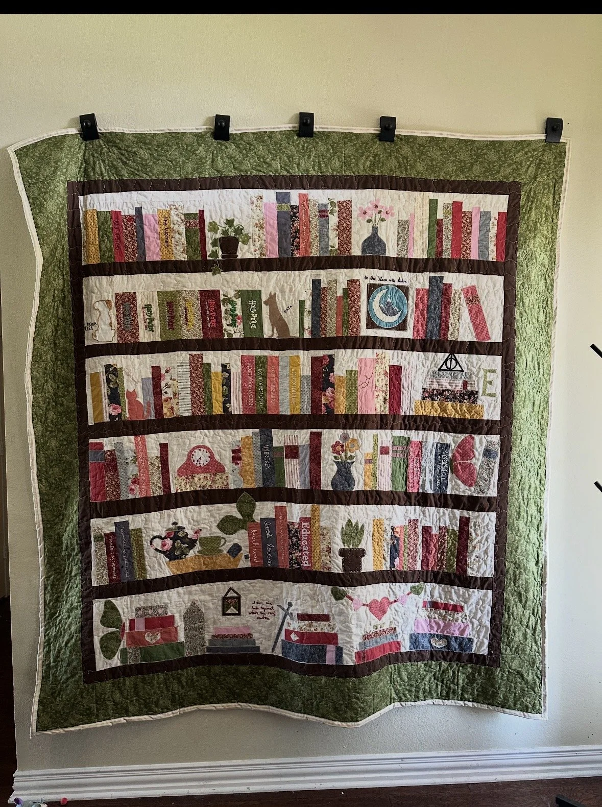 This one was a custom for a client. I hand embroidered most of the book titles. Butterfly is AccuQuilt, as is tea pot, cat and heart.The others I drew or just cut out as I was going.  