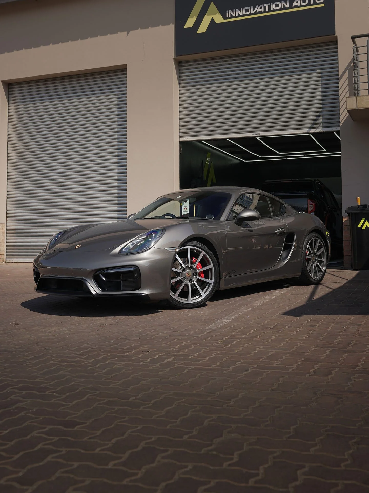 Grey Porsche Cayman outside Innovation Auto in Kyalami after ceramic coating