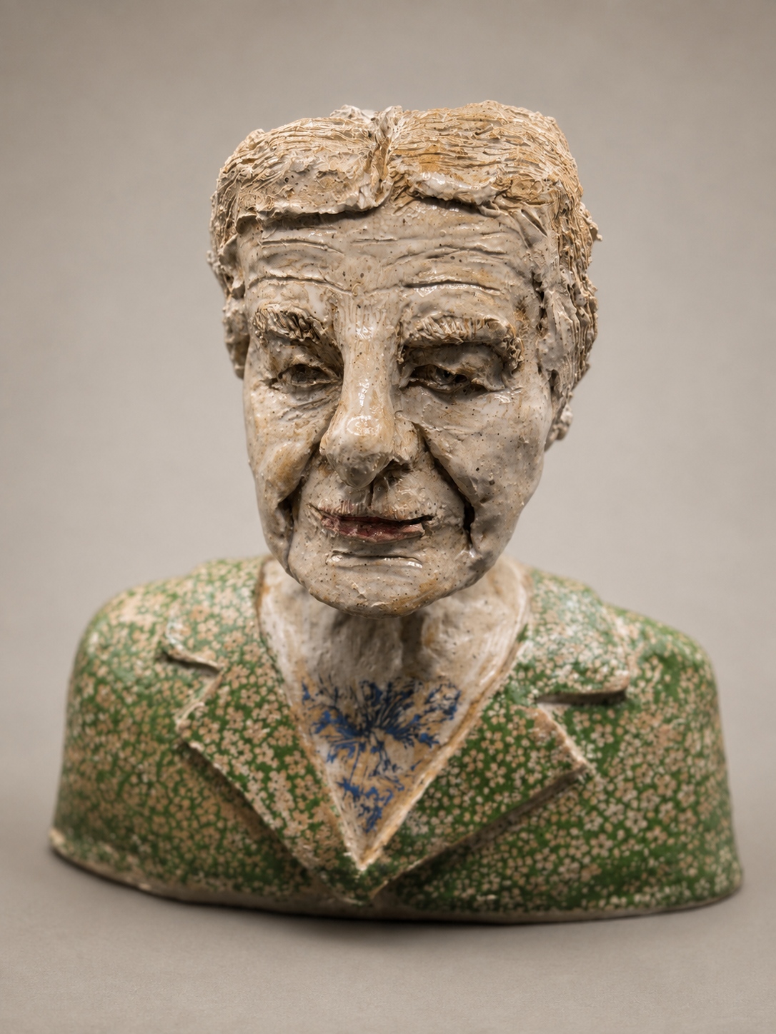 Ceramic bust of an elderly woman wearing a green patterned jacket and blue floral shirt. Israel Prime Minister Female