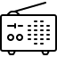 A black cat sitting on a white surface against a dark background.