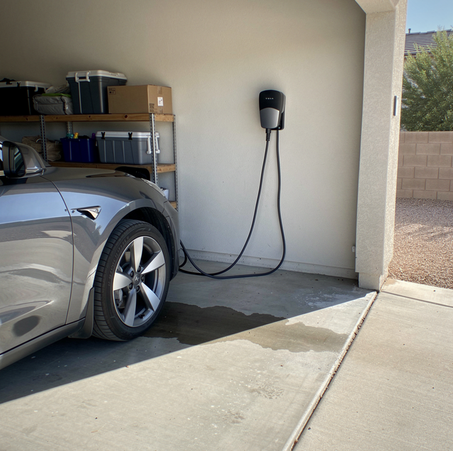 Electric car charging station mounted in residential garage