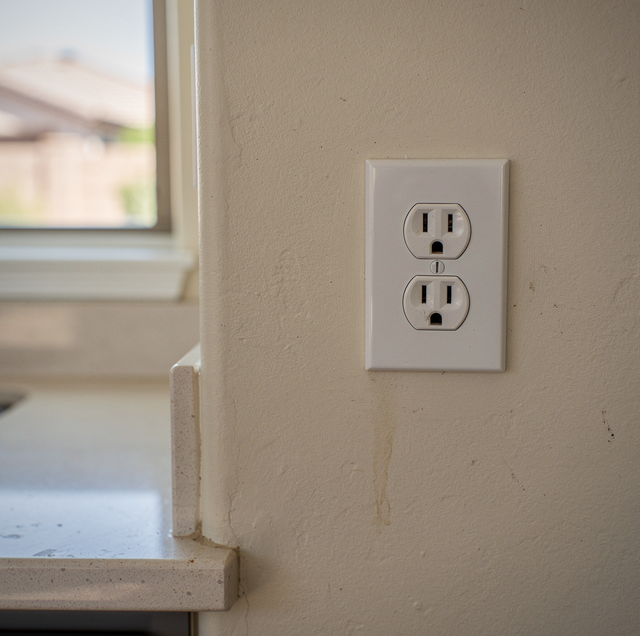 scorched electrical outlet with burn marks on wall