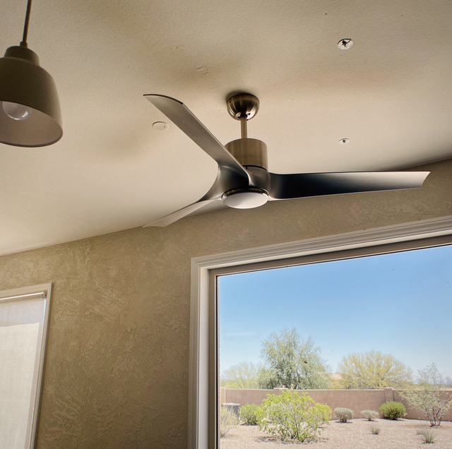 Modern ceiling fan mounted in high ceiling living room