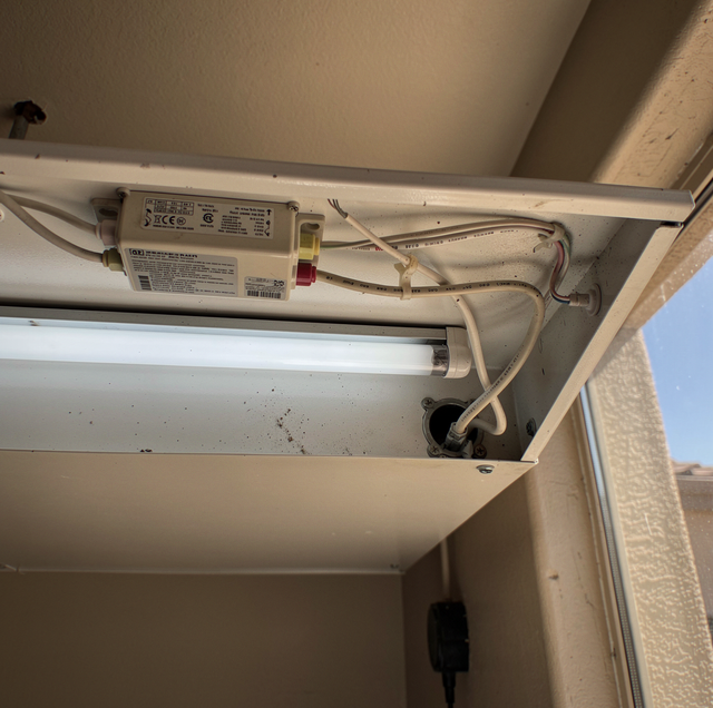 opened fluorescent light ballast showing copper coil windings