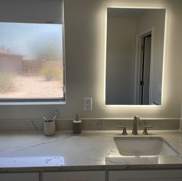 modern bathroom vanity with warm layered lighting