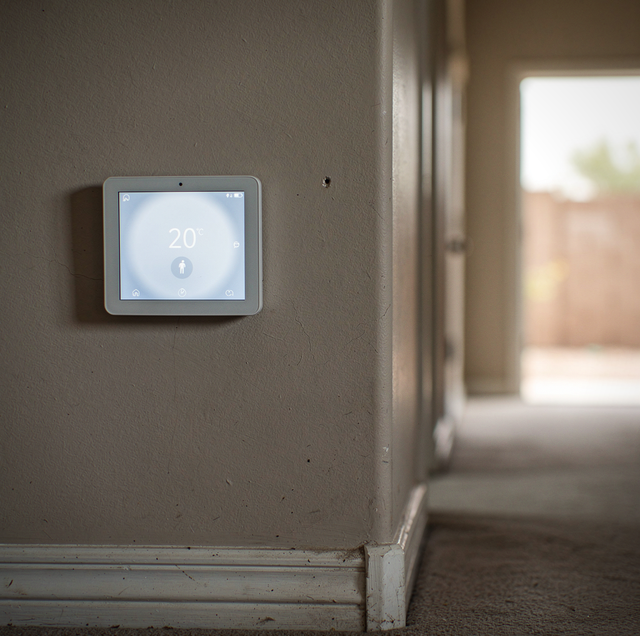 smart thermostat mounted on living room wall
