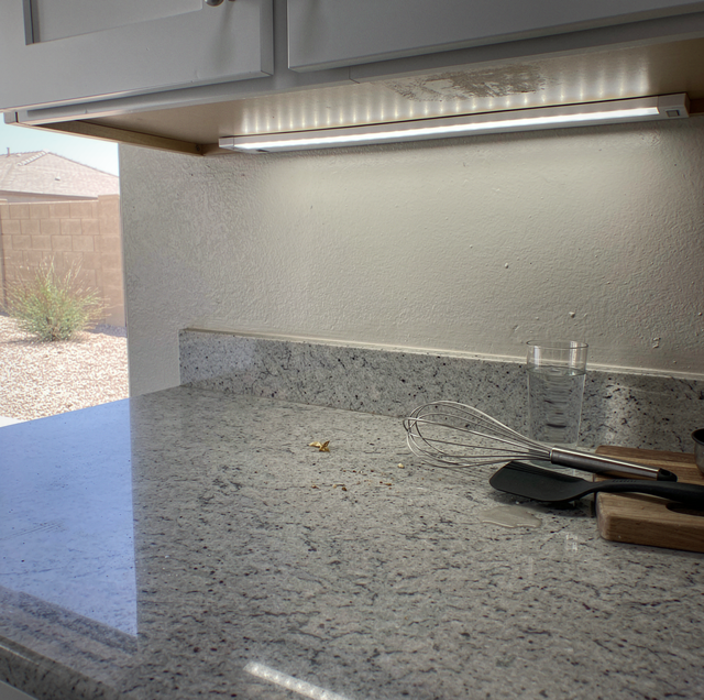 custom LED strip lighting installed under modern kitchen cabinets