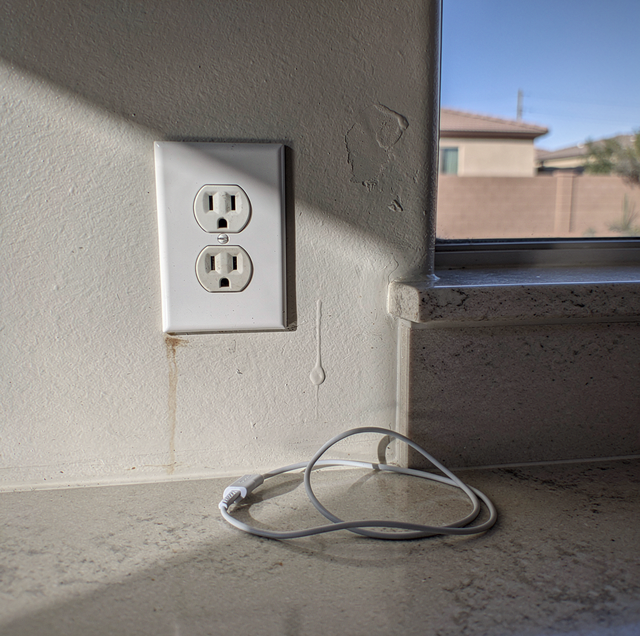 Burnt electrical outlet with scorch marks on wall