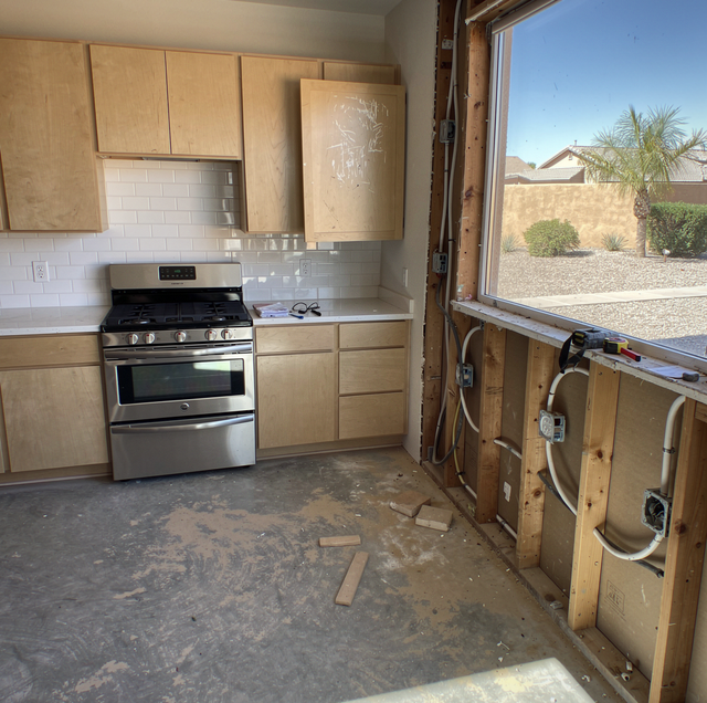 Electrician installing new wiring in renovated wall