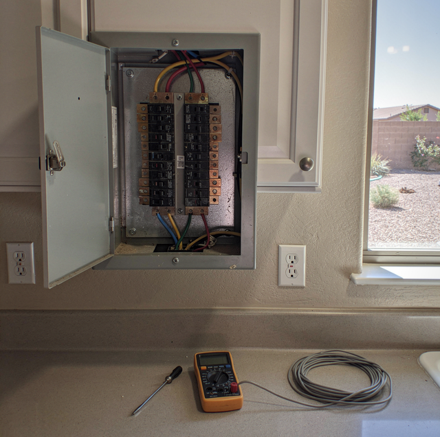 sparking electrical outlet with frayed wires on wall