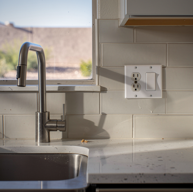 Electrician installing new outlet in modern home