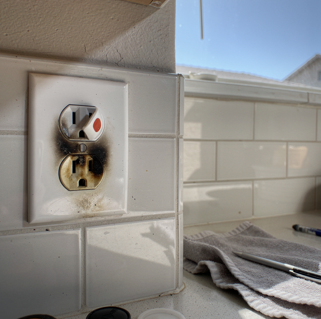 burnt electrical outlet with scorch marks on wall