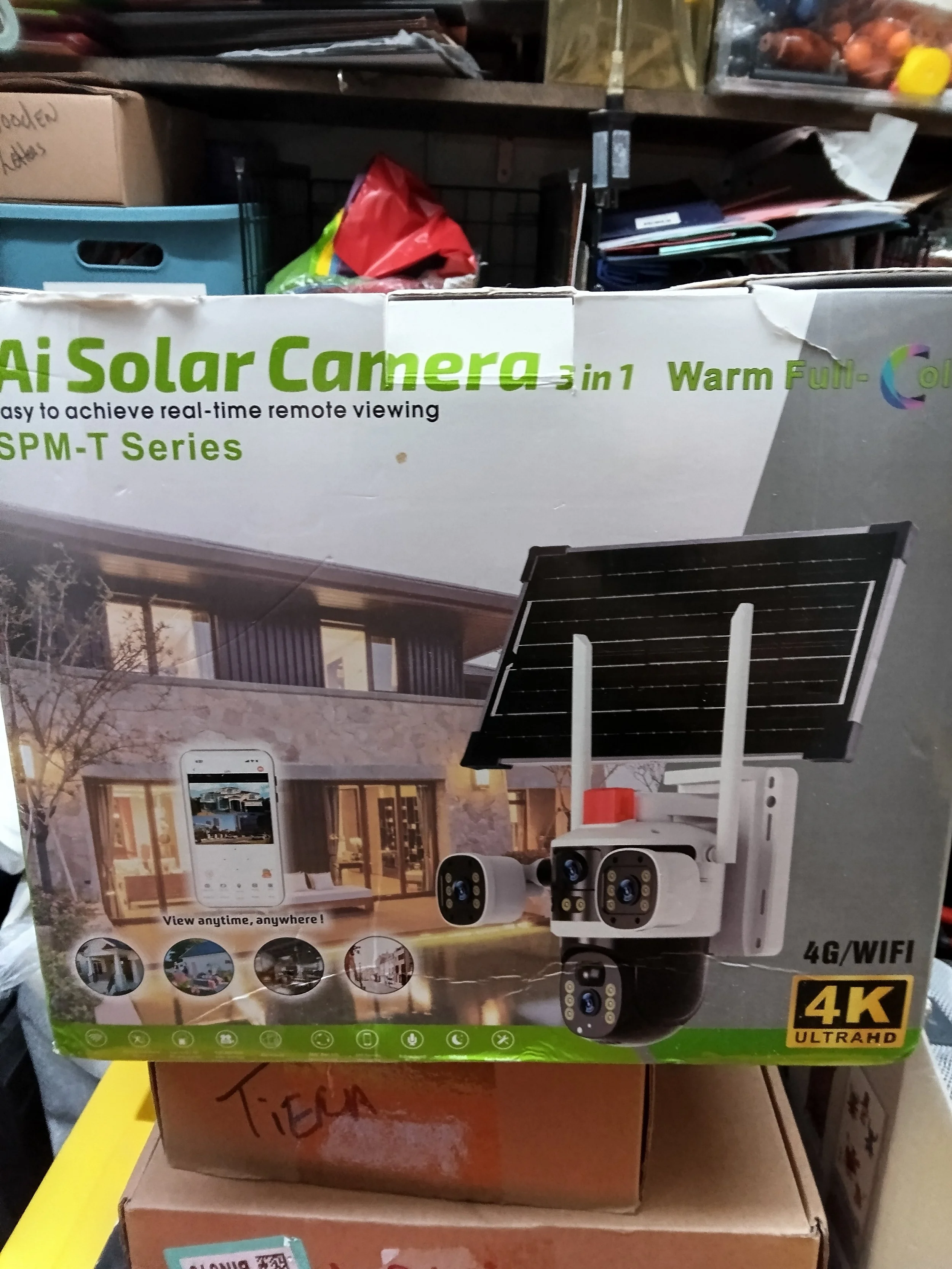 Box labeled 'AI Solar Camera 3 in 1 Warm Full Color' showing a solar-powered security camera system with remote viewing capabilities, wireless 4G/WIFI connectivity, suitable for home security, with illustrations of a house, smartphone, and camera system.