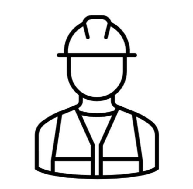 A construction worker wearing a safety vest and helmet standing next to a large crane on a truck, with a construction site and building crane in the background.