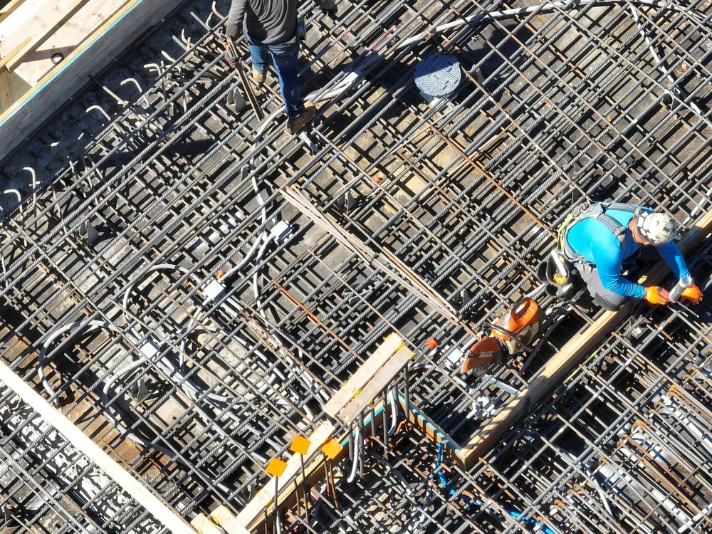 Construction workers installing rebar on a building site