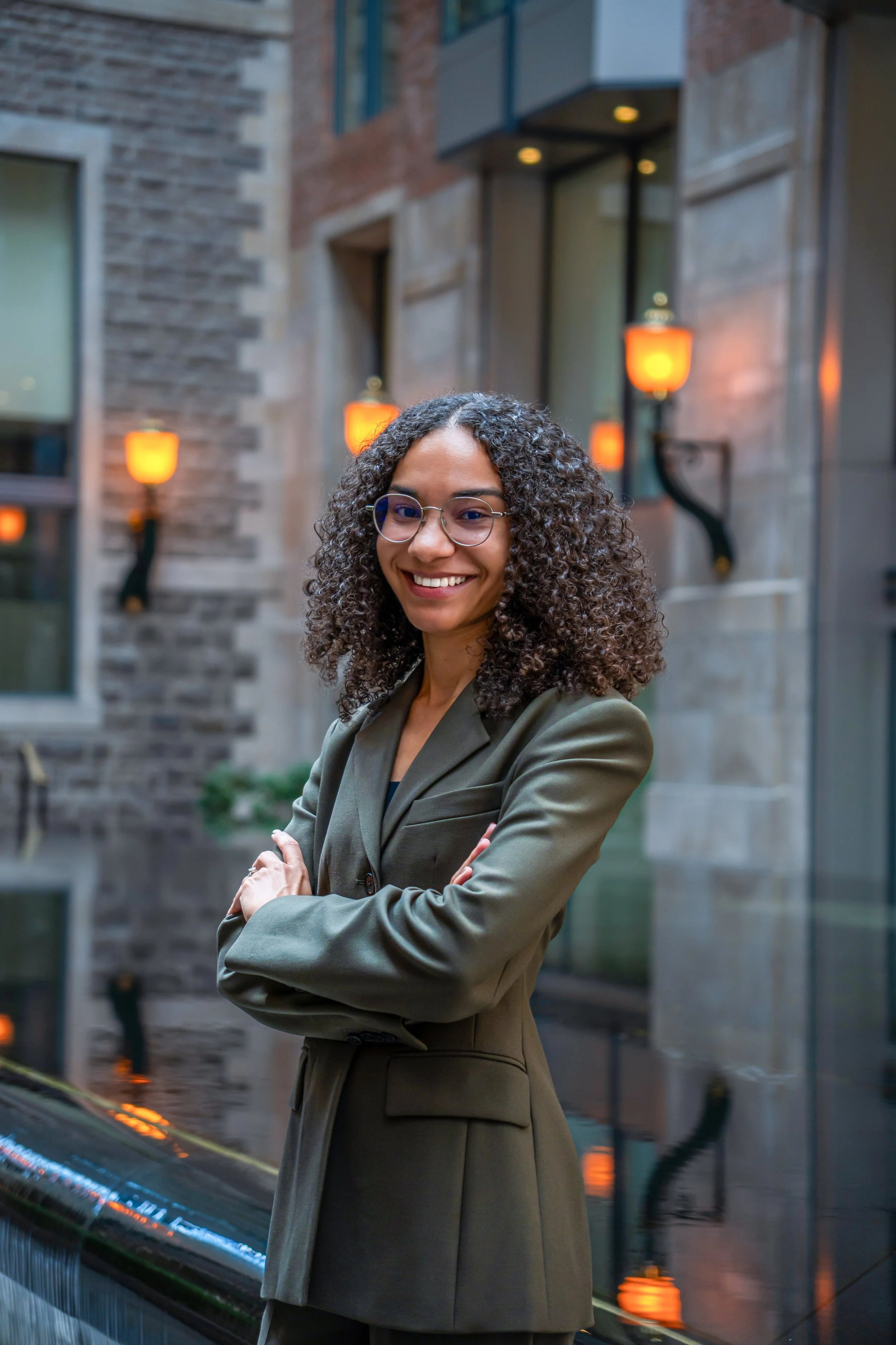 April Nutakor, Ottawa immigration lawyer and founder of Nutakor Law, smiling in front of a stone building