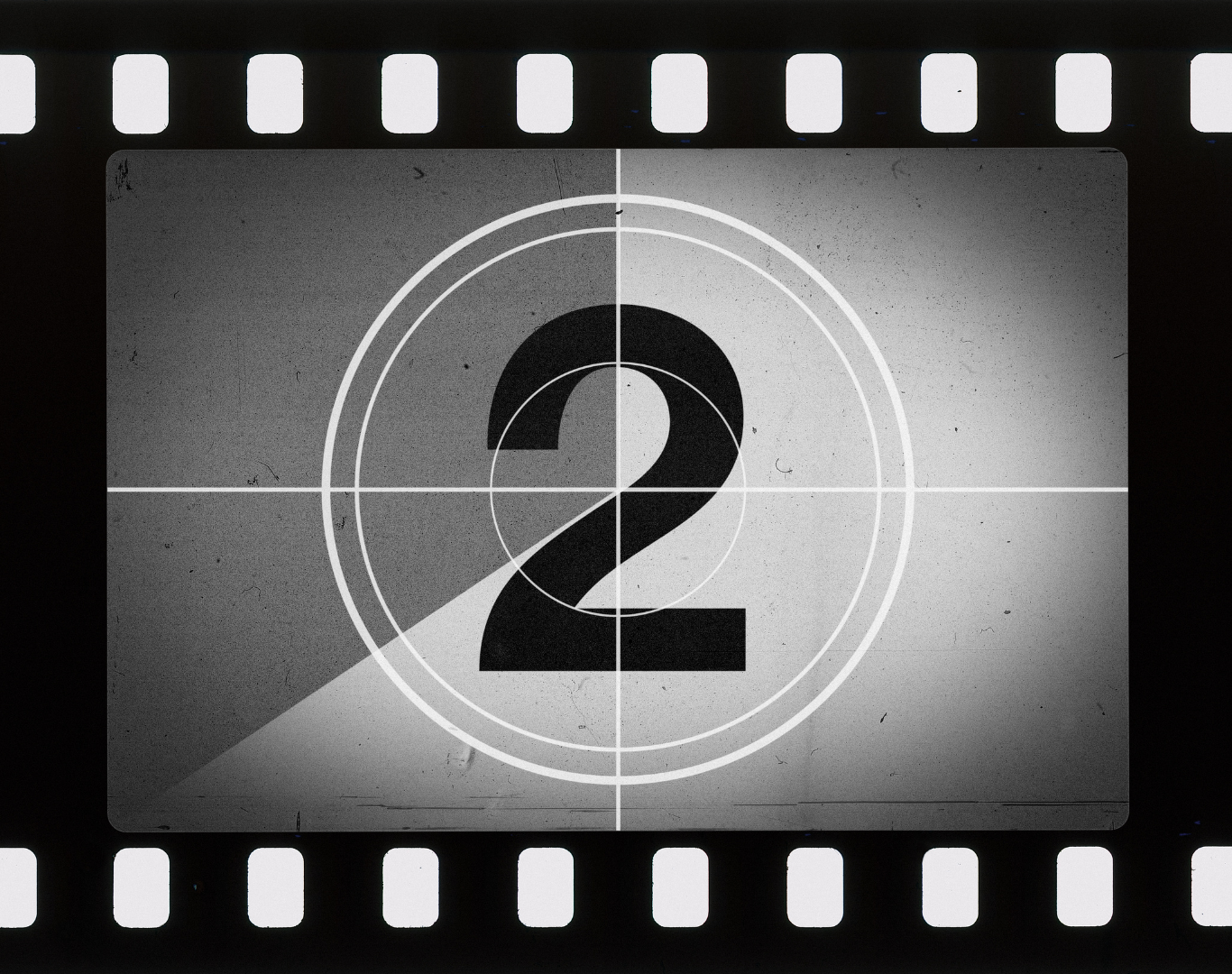 Black and white vintage film countdown timer showing the number 2 with film strip edges.