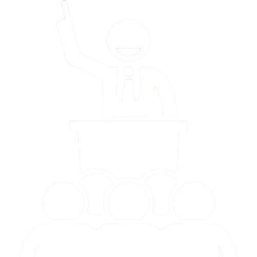 Silhouette of a person at a podium speaking to an audience, raising one hand.