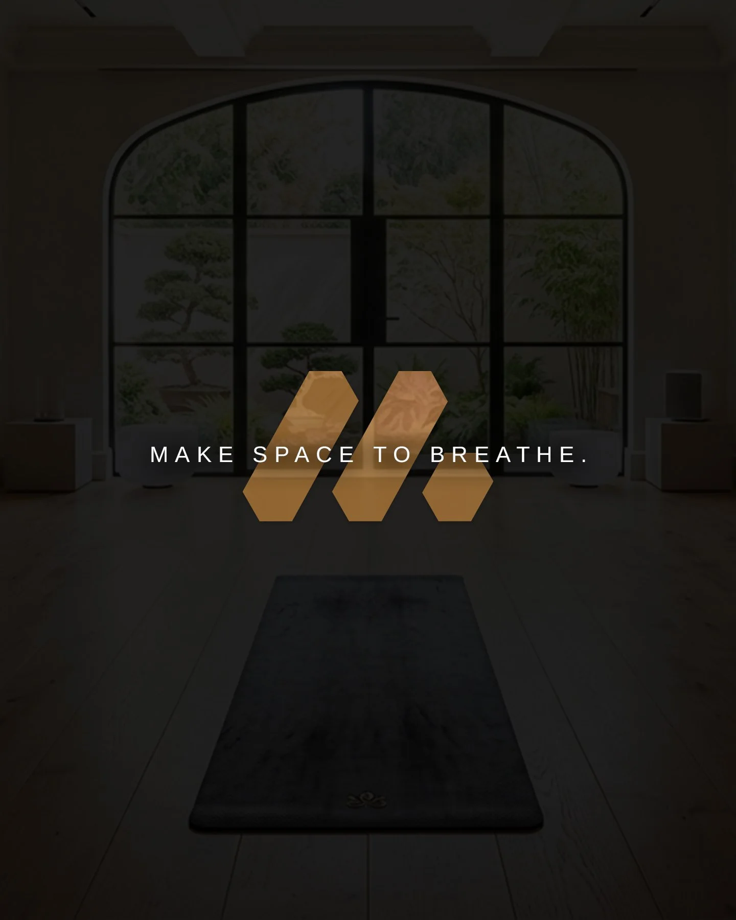 Interior view of a room with a large arched window showing a garden outside. Overlay text reads 'MAKE SPACE TO BREATHE' with three stylized bars in front.