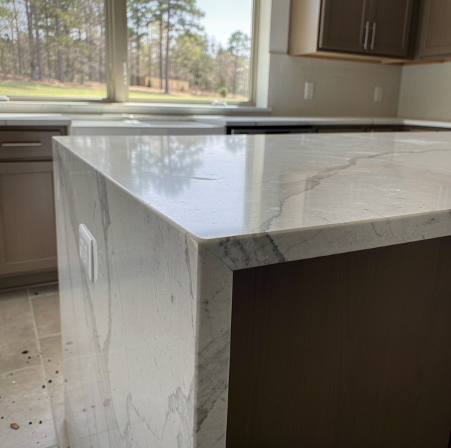 Marble waterfall island edge with mitered corner seam