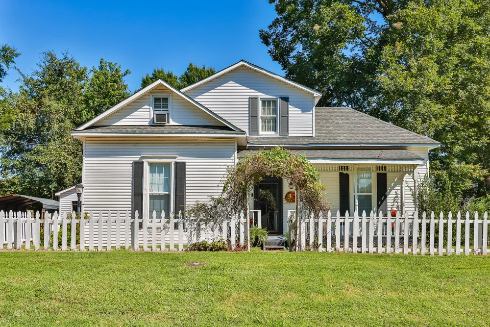 White farmhouse with a picket fence