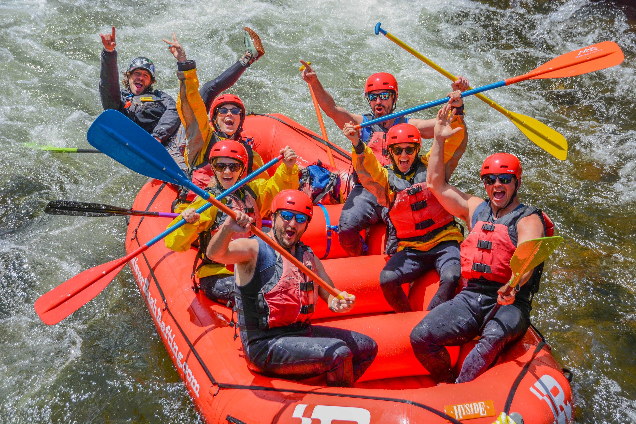 Friends and famiily having a great time white water rafting in the Rocky Mountains, near Denver, Colorado.