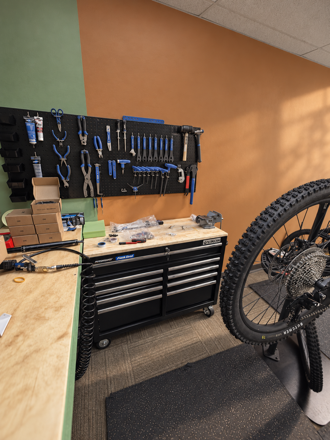 Bike repair workshop with assorted bike parts, and mountain bikes in the Rocky Mountains near Denver, Colorado.