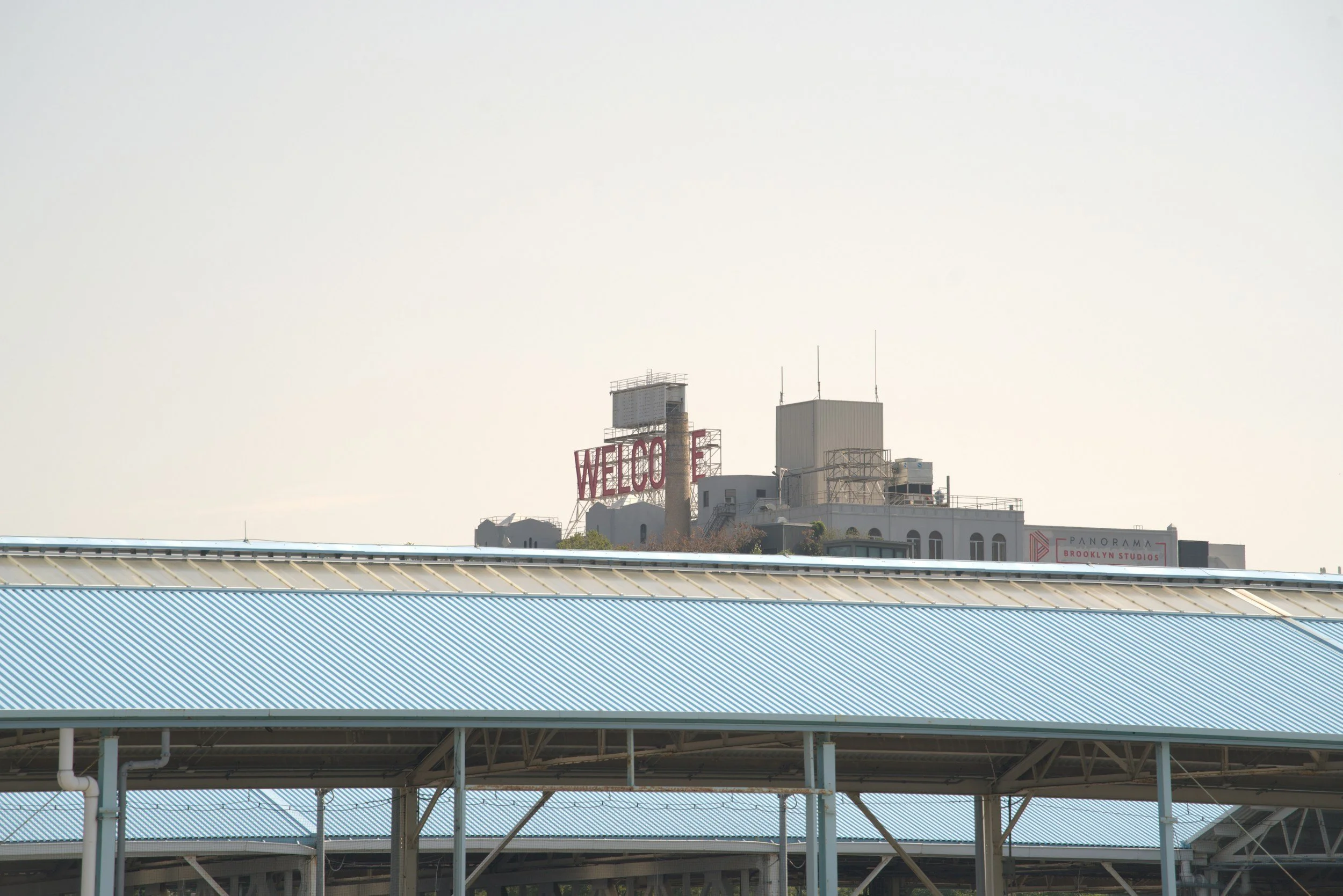 Image of buildings under a clear sky, viewed from a distance.