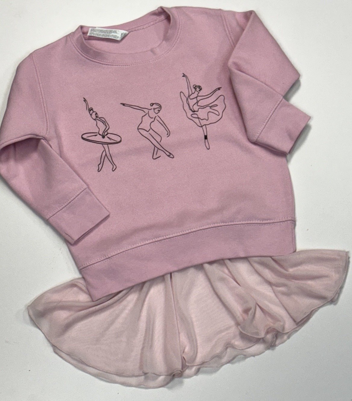 Pink sweatshirt with line drawings of three ballet dancers and a pink tutu skirt