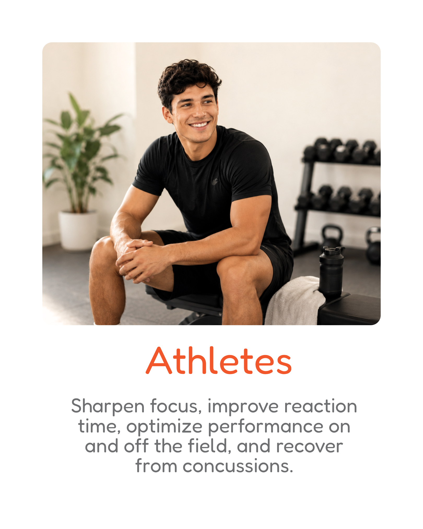 A young man sitting on a bench in a gym, smiling, with dumbbells on a rack behind him and a water bottle on the bench, representing athletes.