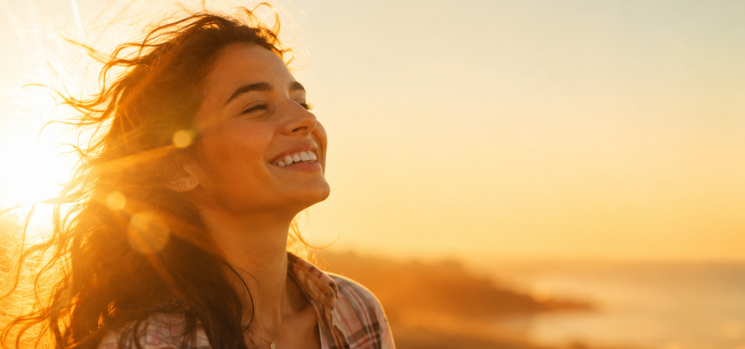 Women with brown hair smiling with sunrays