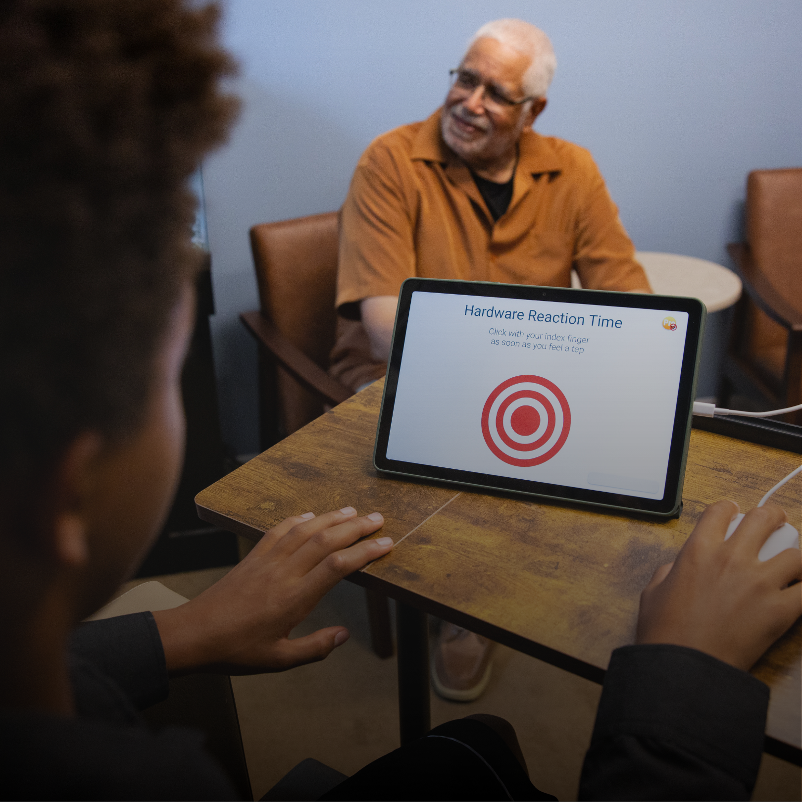 Image of kid doing Brain Gauge while an adult is watching him