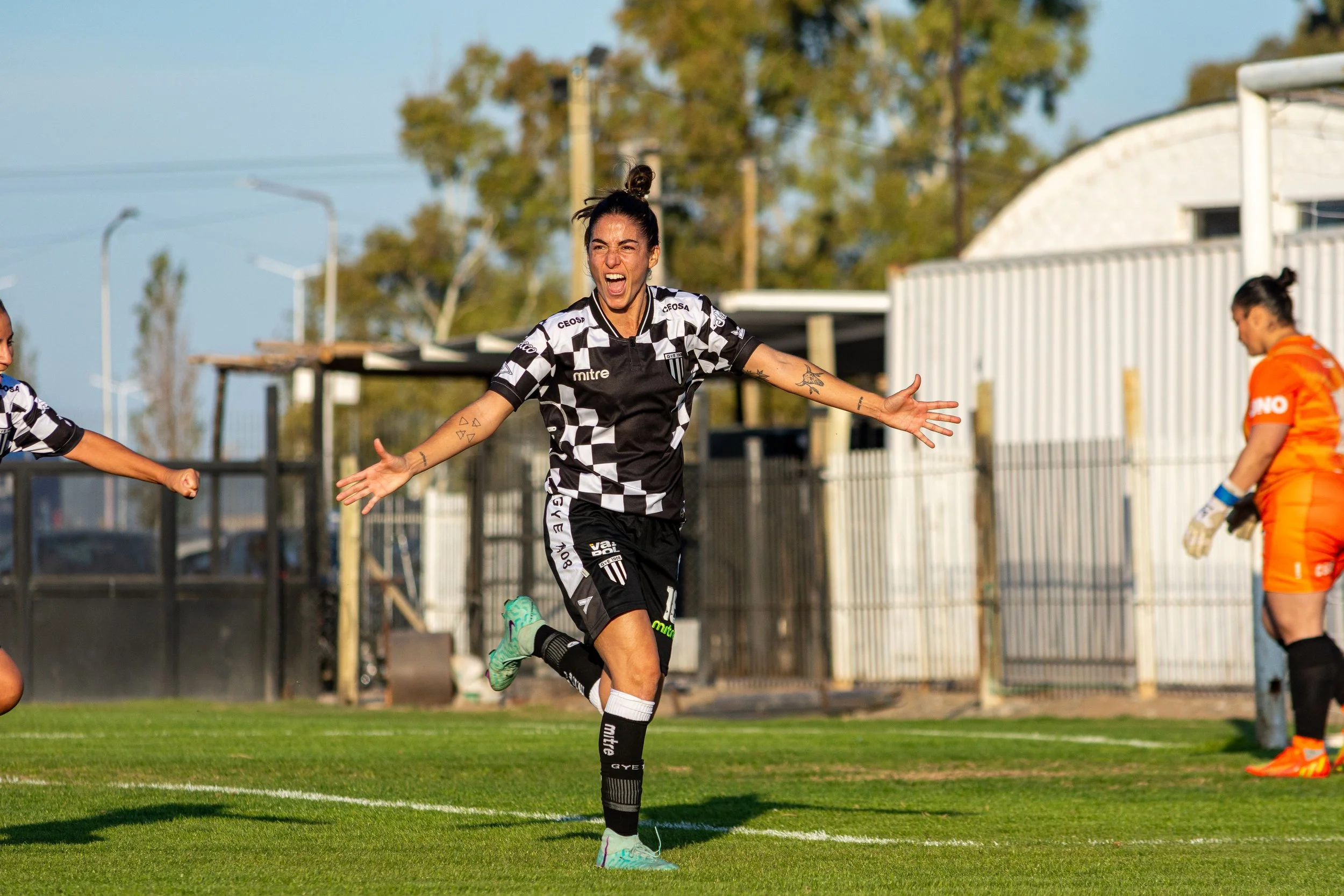 Image of women soccer play with her arms open