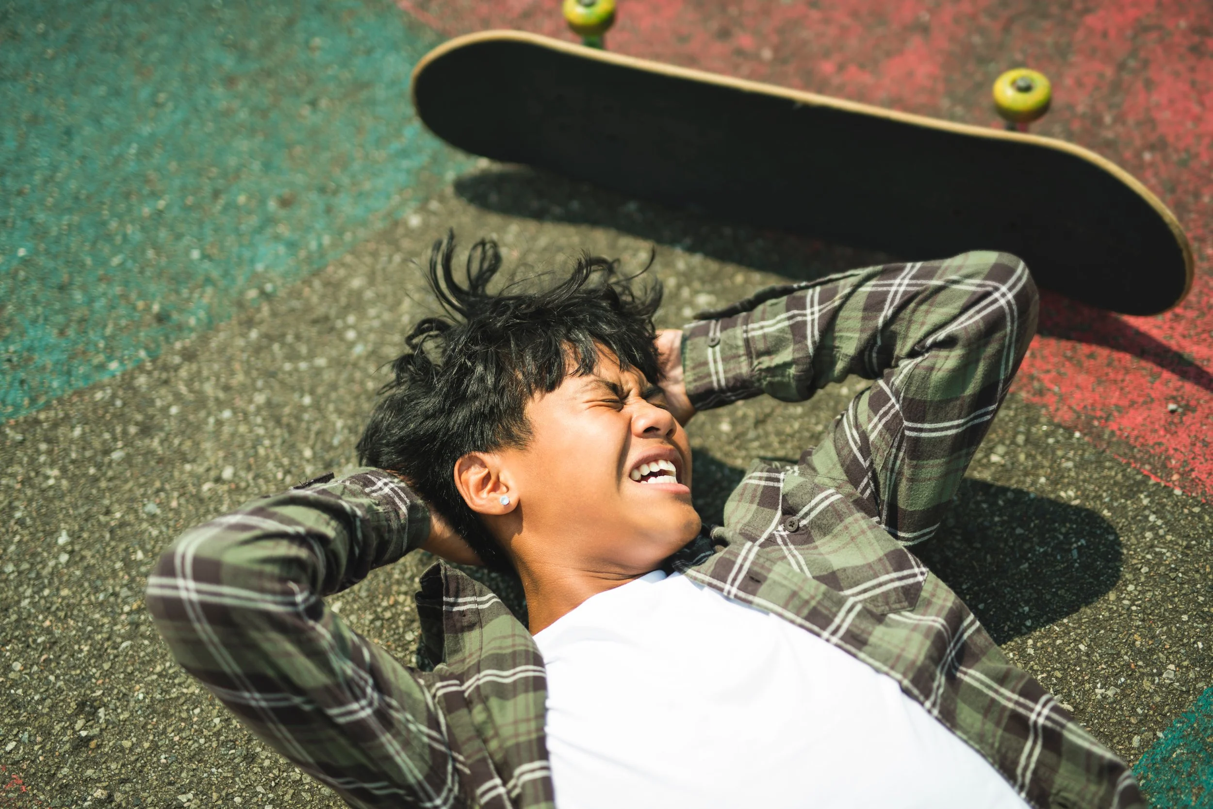 Young man holding his head while experiencing pain or discomfort