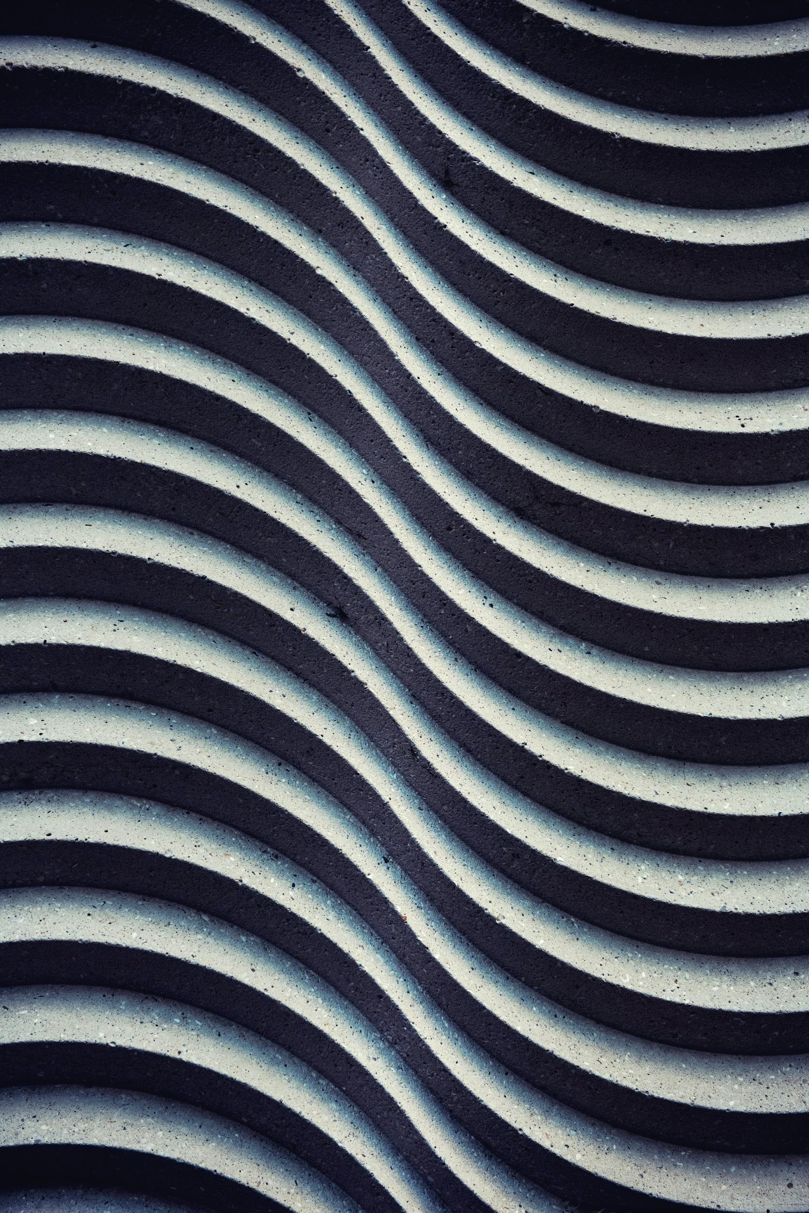 Close-up of a black and white striped textured surface with curved lines.