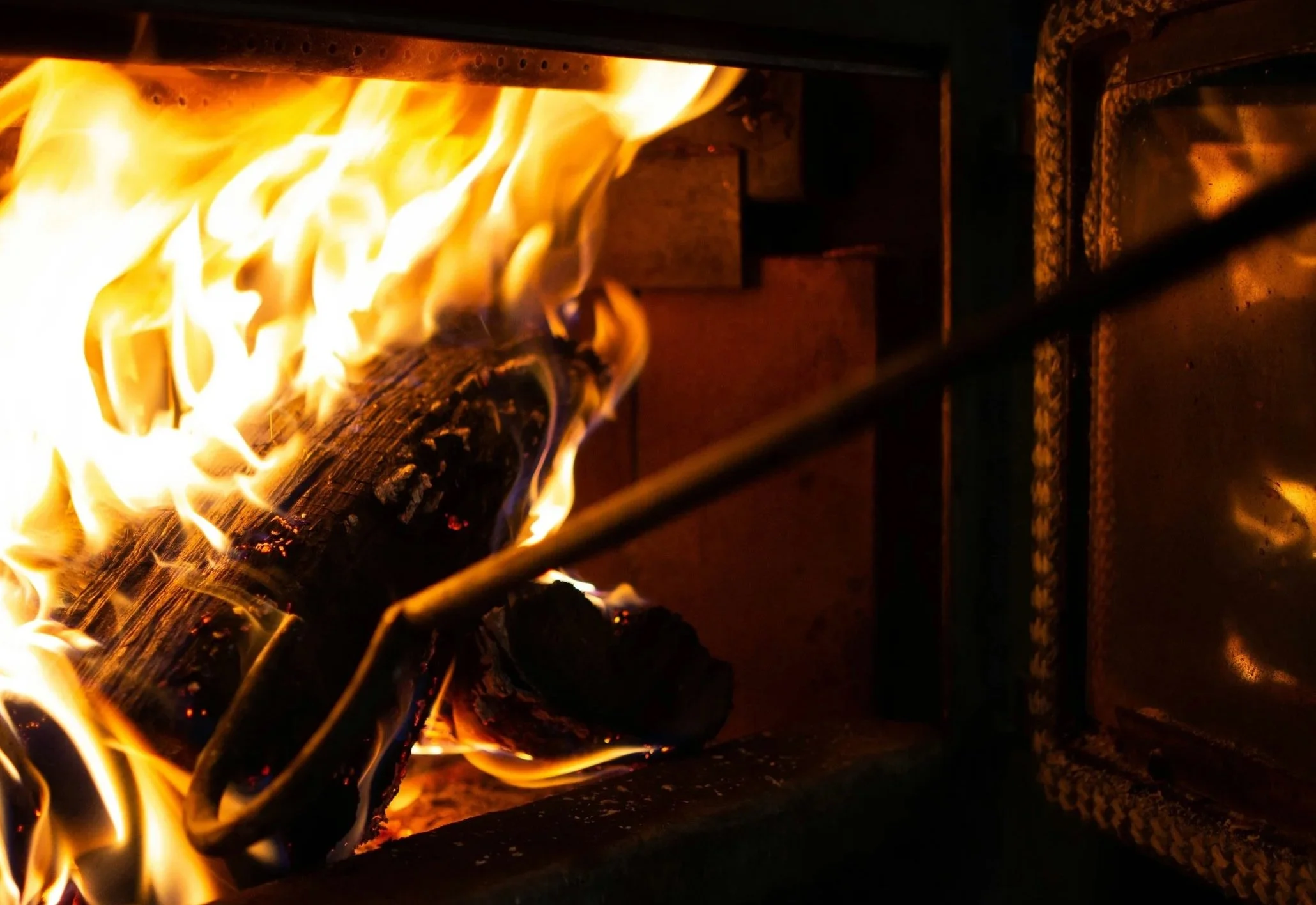 Close-up of a fire burning logs inside a fireplace