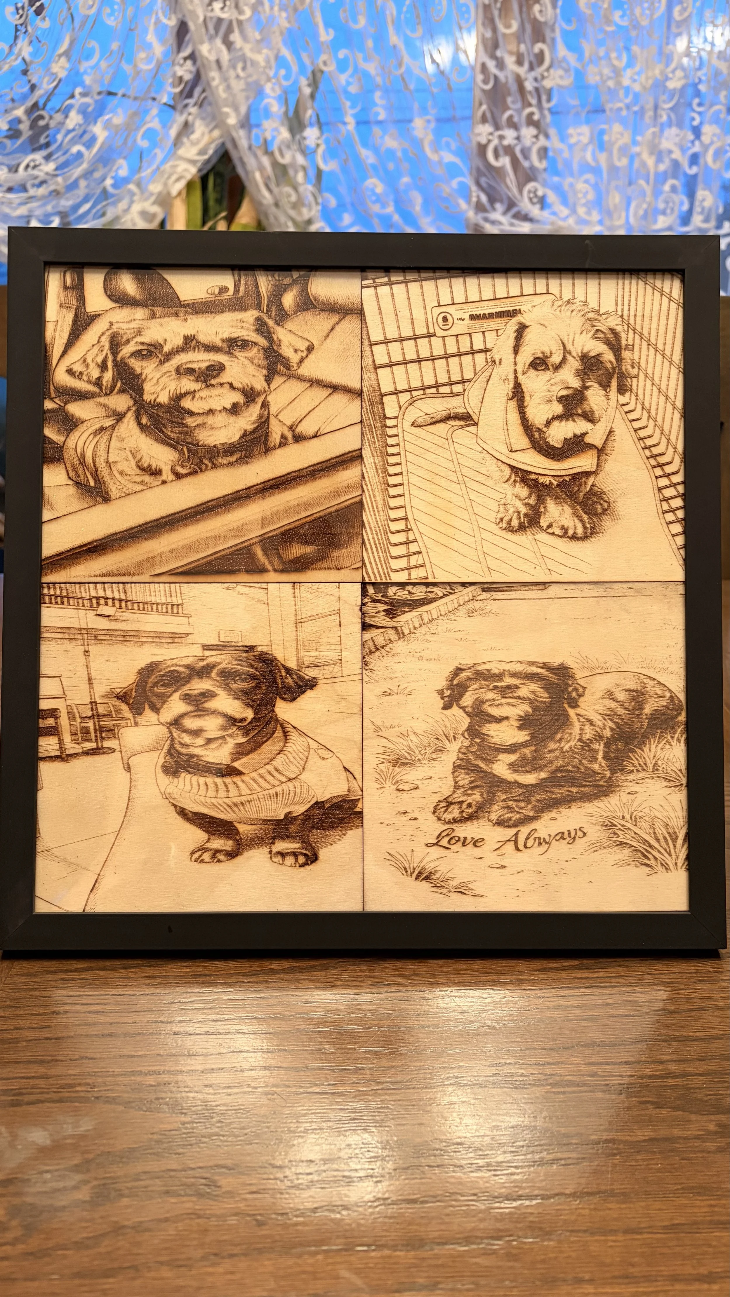 A framed artwork featuring four detailed sketches of different dogs on a wooden table. The sketches include a dog with a collar in a car, a small dog in a shopping cart, a dog wearing a sweater, and a sitting dog with the words "Love Always" inscribe