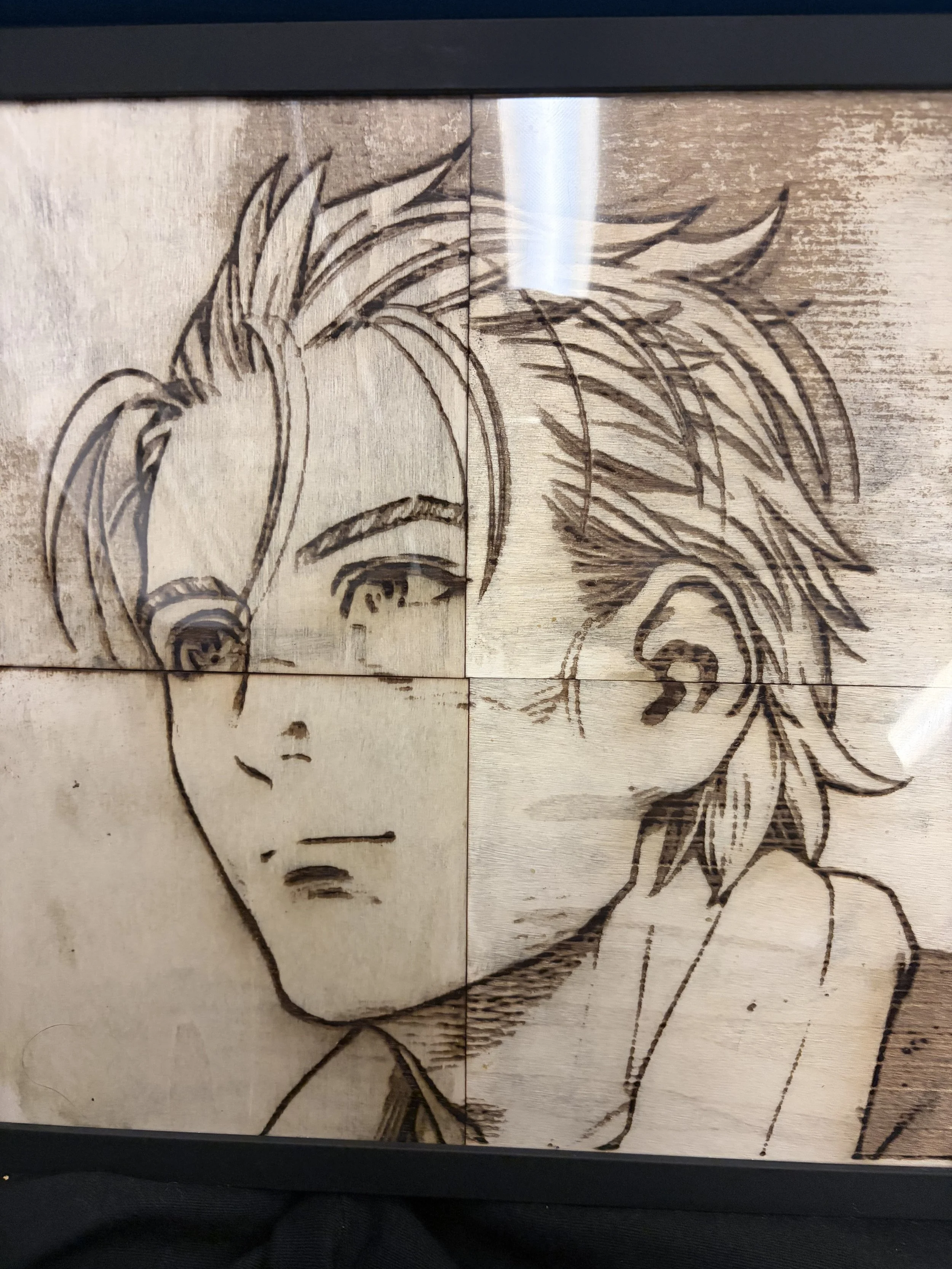 Laser-etched portrait of a woman with long hair on wooden panels.