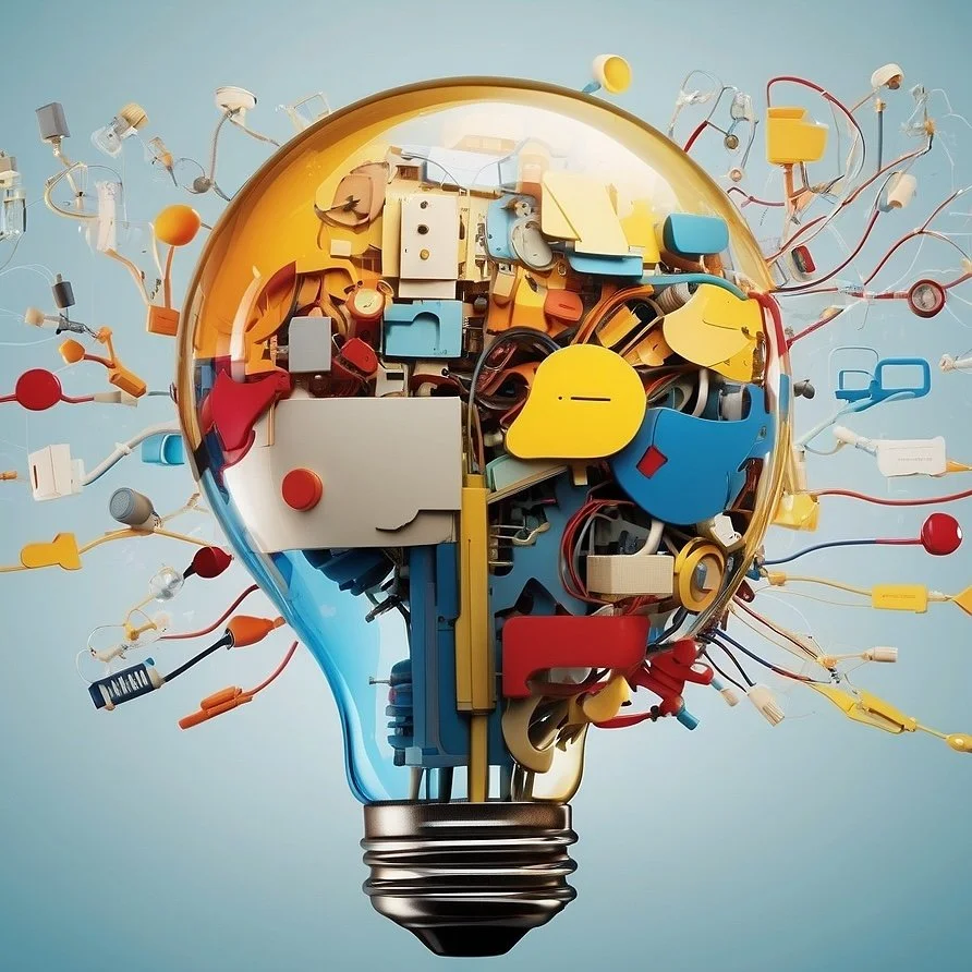 A light bulb-shaped sculpture made of colorful plastic parts and electrical components, with wires extending outward resembling a brain.