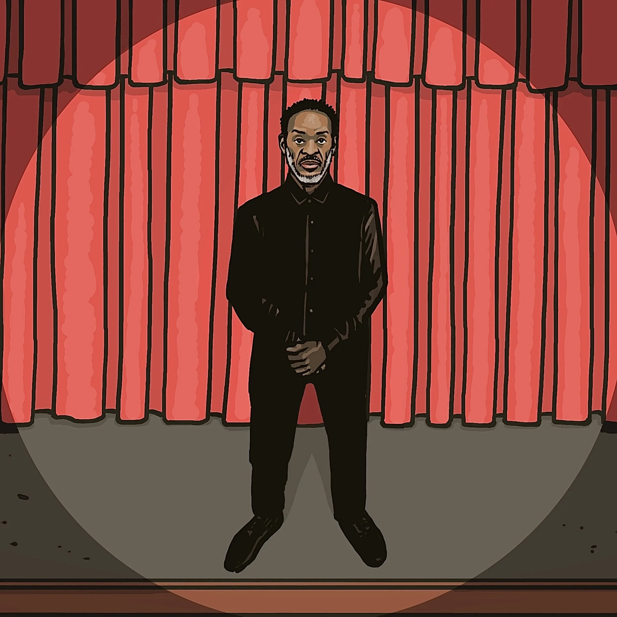 A man standing in front of a stage with red curtains, wearing a black shirt, barefoot, with a serious expression.