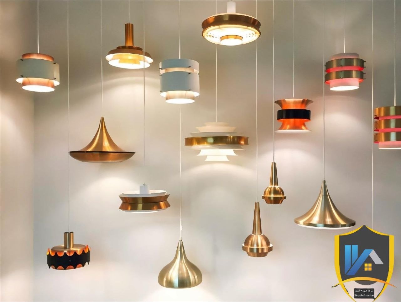 Collection of hanging modern pendant lights with metallic finishes in gold, copper, and mixed colors, displayed against a plain background.
