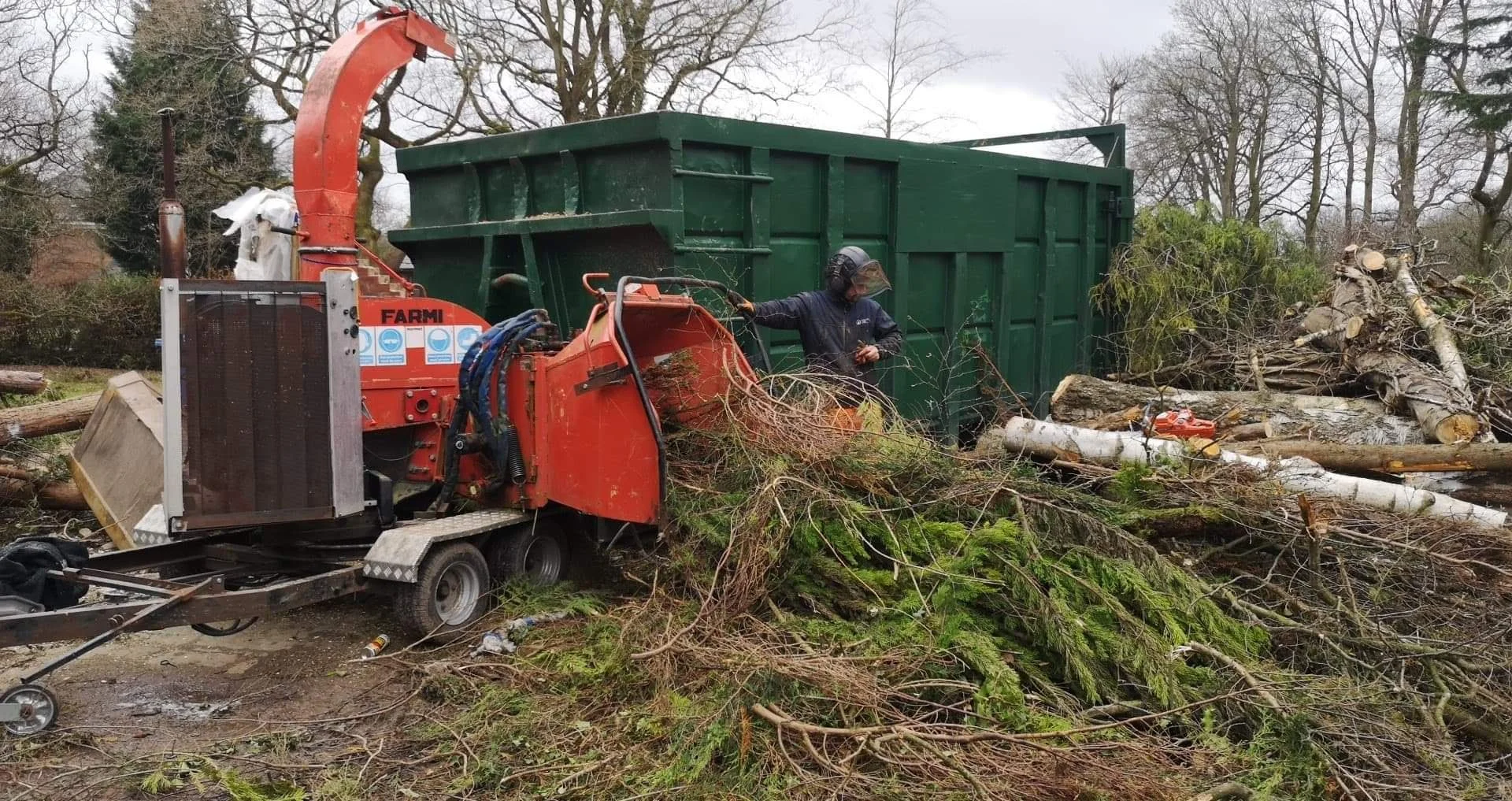 Farmi wood chipper processing branches and timber from professional tree surgery operations.